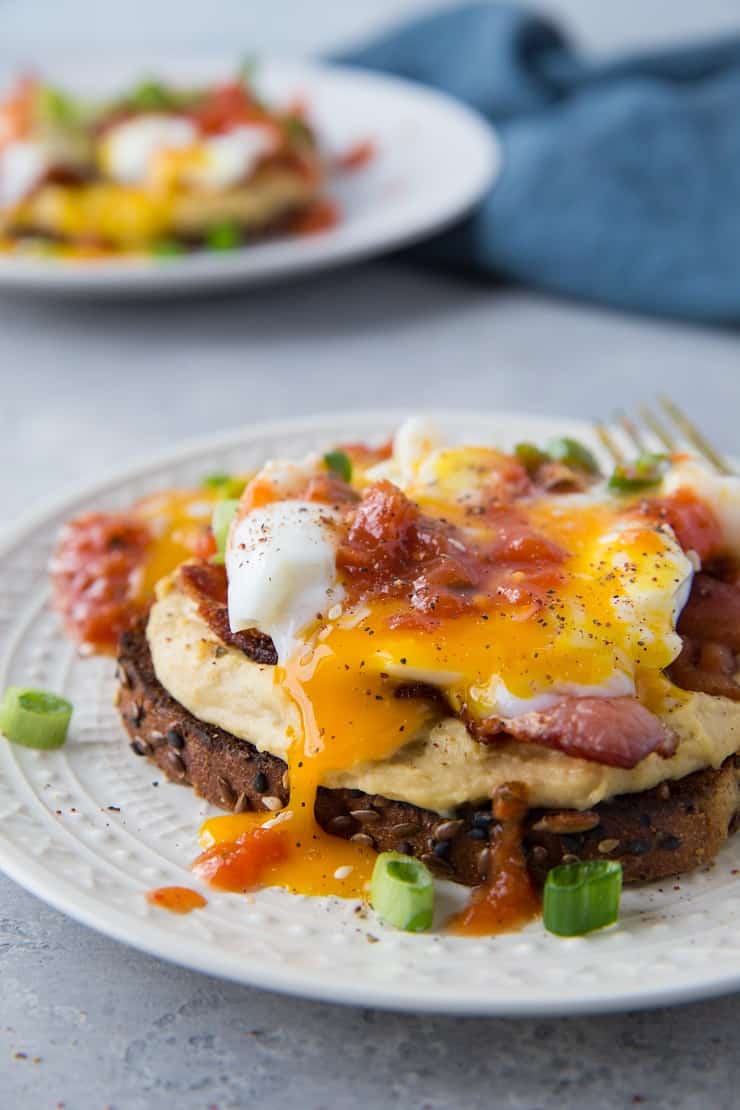 Huevos Rancheros Hummus Toast with soft boiled egg, bacon, and salsa | TheRoastedRoot.net #hummustoast #breakfast