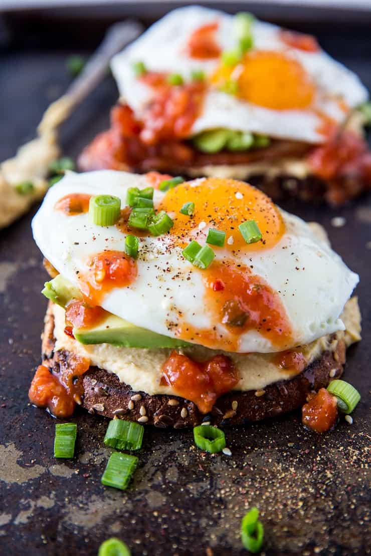 Huevos Rancheros Hummus Toast with soft boiled egg, bacon, and salsa | TheRoastedRoot.net #hummustoast #breakfast