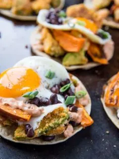 Crispy Avocado Breakfast Tacos with roasted sweet potato, cauliflower, black beans, eggs, and chipotle sauce. A healthy brunch recipe | TheRoastedRoot.net #glutenfree #breakfast