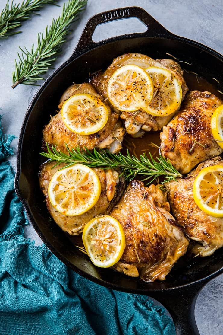 Lemon rosemary braised chicken thighs in a cast iron skillet
