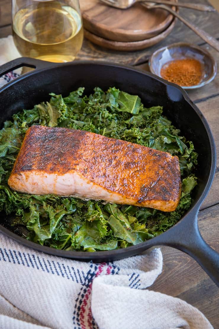 Blackened Salmon with Garlicky Cajun Kale - a healthy low-carb, keto dinner recipe from the cookbook, The Quintessential Kale Cookbook by Julia Mueller | TheRoastedRoot.net