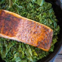 Blackened Salmon with Garlicky Cajun Kale - a healthy low-carb, keto dinner recipe from the cookbook, The Quintessential Kale Cookbook by Julia Mueller | TheRoastedRoot.net