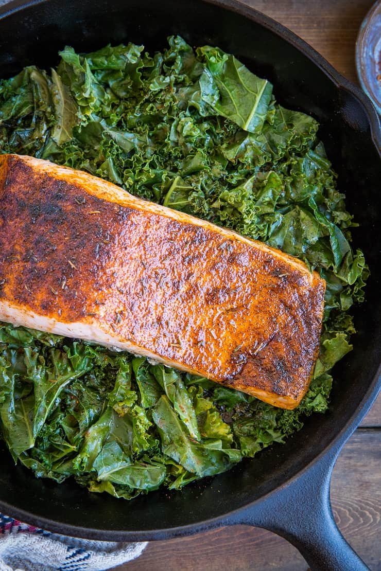 Blackened Salmon with Garlicky Cajun Kale - a healthy low-carb, keto dinner recipe from the cookbook, The Quintessential Kale Cookbook by Julia Mueller | TheRoastedRoot.net