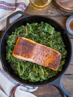 Blackened Salmon with Garlicky Cajun Kale - a healthy low-carb, keto dinner recipe from the cookbook, The Quintessential Kale Cookbook by Julia Mueller | TheRoastedRoot.net