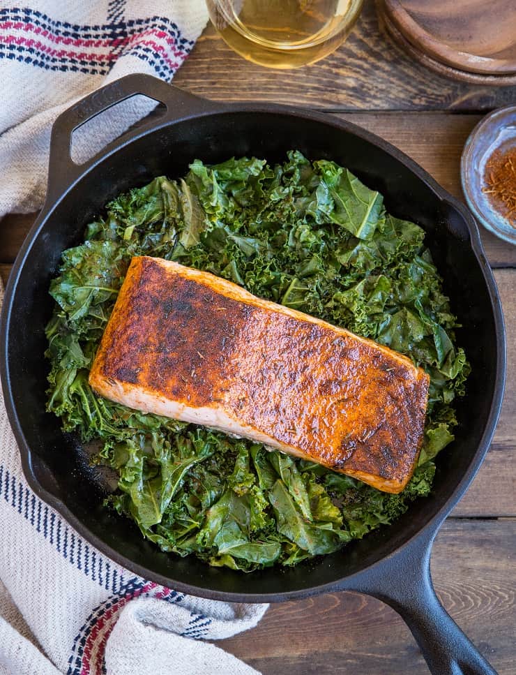 Blackened Salmon with Garlicky Cajun Kale - a healthy low-carb, keto dinner recipe from the cookbook, The Quintessential Kale Cookbook by Julia Mueller | TheRoastedRoot.net