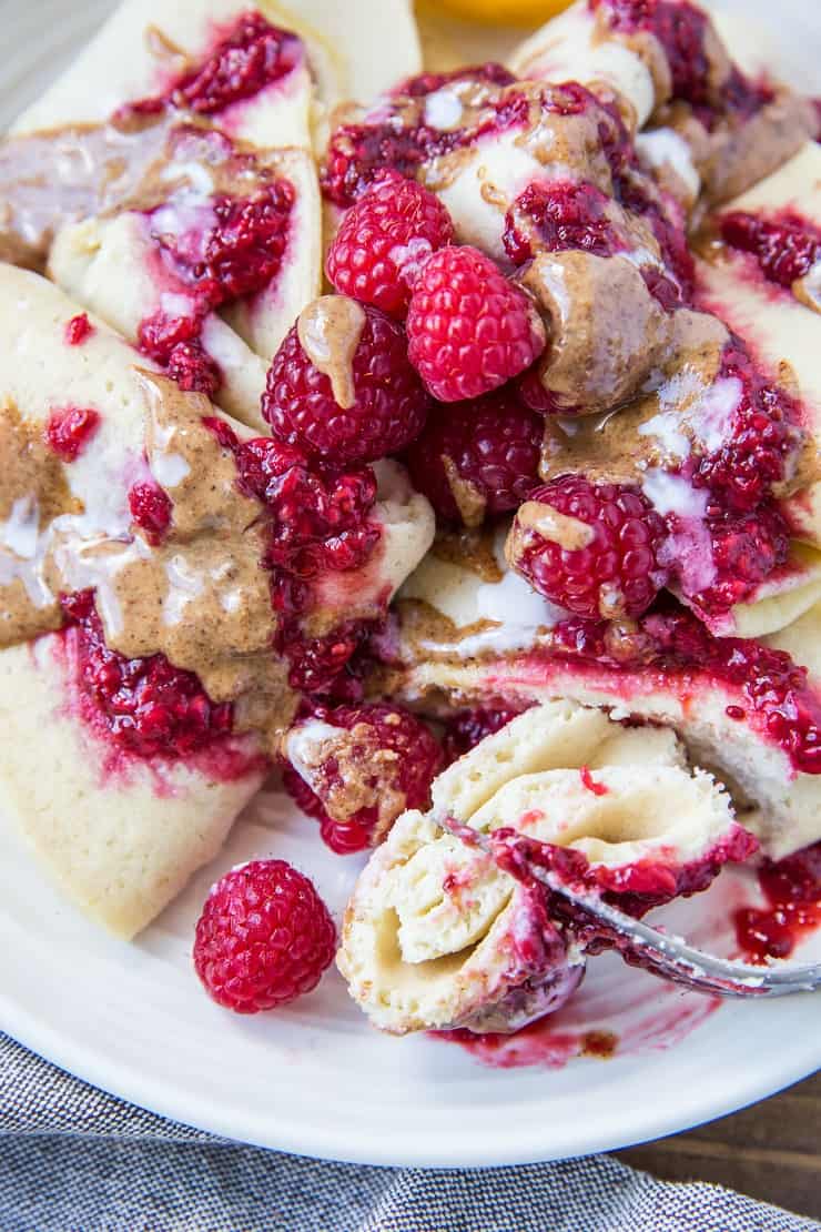 Grain-Free Almond Flour Crepes topped with almond butter and raspberry chia jam - a healthy and delicious breakfast | TheRoastedRoot.net #glutenfree #dairyfree