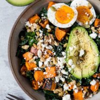 Roasted Sweet Potato Kale Salad with Avocado, Jammy Egg, Pumpkin Seeds, and Walnuts. A filling and nutritious dinner salad | TheRoastedRoot.net