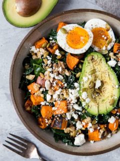 Roasted Sweet Potato Kale Salad with Avocado, Jammy Egg, Pumpkin Seeds, and Walnuts. A filling and nutritious dinner salad | TheRoastedRoot.net