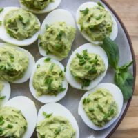 Avocado Pesto Deviled Eggs - Mayo-free deviled eggs made with avocado and fresh basil for a healthy snack or appetizer | TheRoastedRoot.net