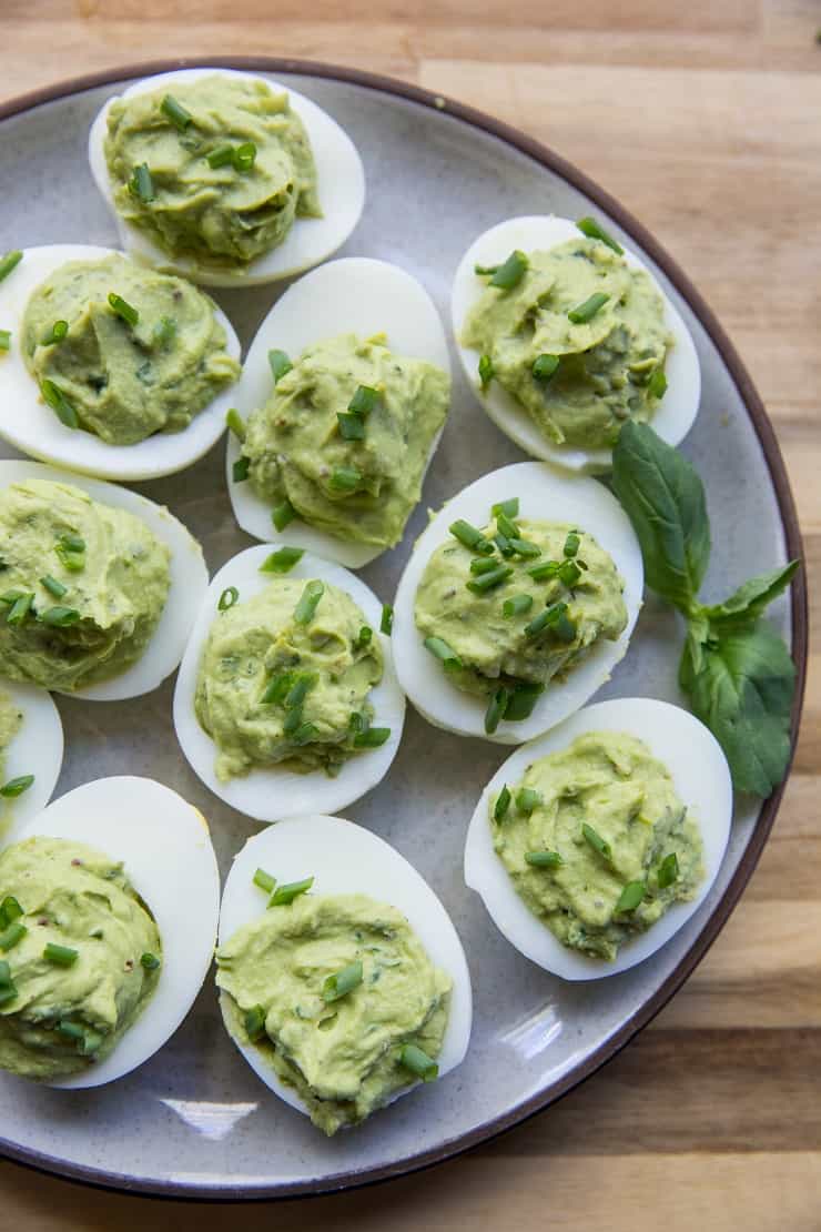 Avocado Pesto Deviled Eggs - Mayo-free deviled eggs made with avocado and fresh basil for a healthy snack or appetizer | TheRoastedRoot.net