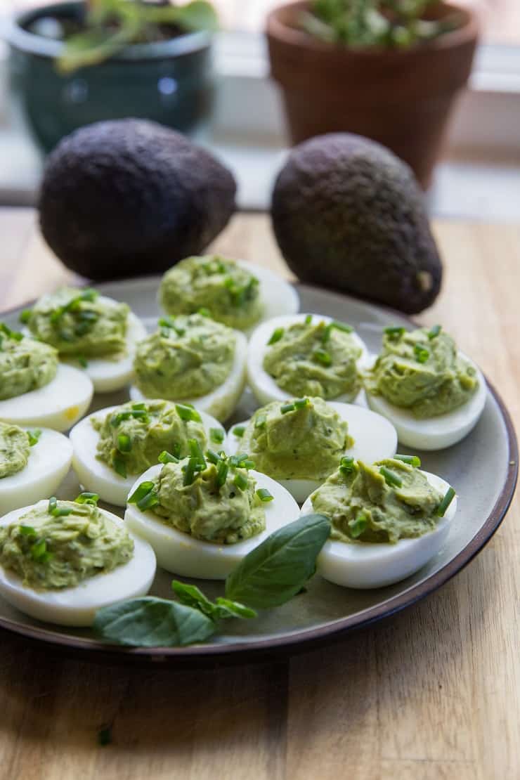 Avocado Pesto Deviled Eggs - Mayo-free deviled eggs made with avocado and fresh basil for a healthy snack or appetizer | TheRoastedRoot.net