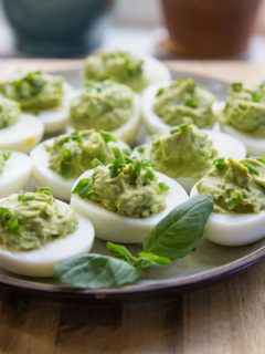 Avocado Pesto Deviled Eggs - Mayo-free deviled eggs made with avocado and fresh basil for a healthy snack or appetizer | TheRoastedRoot.net