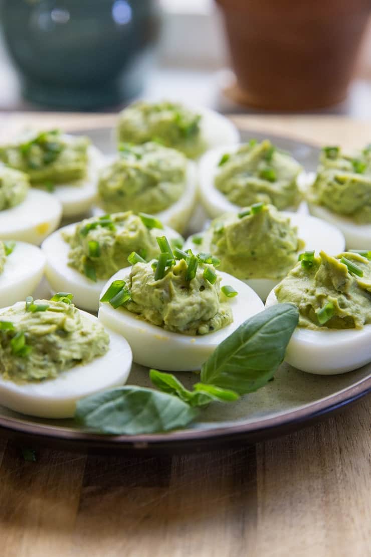 Avocado Pesto Deviled Eggs - Mayo-free deviled eggs made with avocado and fresh basil for a healthy snack or appetizer | TheRoastedRoot.net