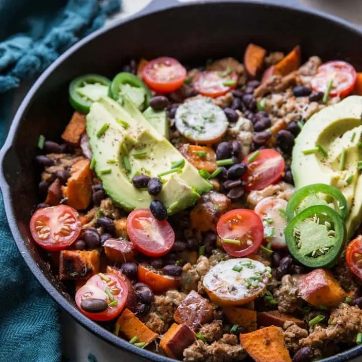 Ground Turkey Taco Skillet with black beans, sweet potato, tomatoes, cheese, avocados, and chives - an easy, clean, healthy dinner recipe ready in just 30 minutes | TheRoastedRoot.net