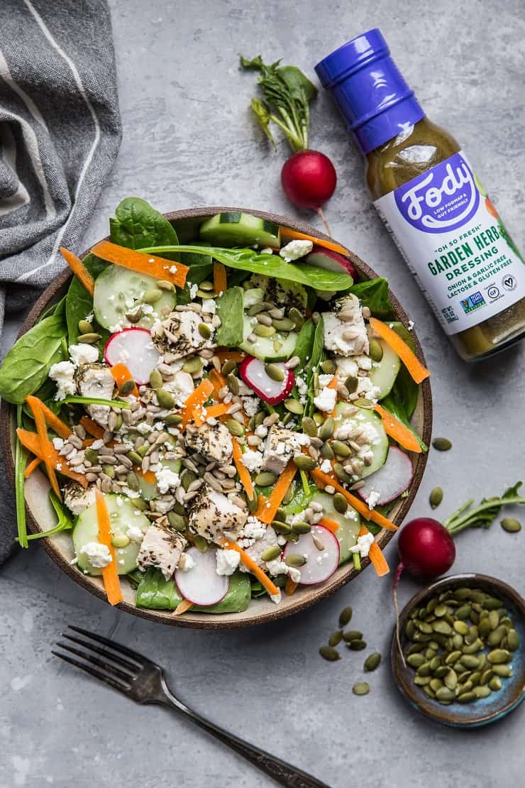 Lemon Herb Baked Chicken Spinach Salad with pumpkin seeds, radishes, cucumbers, feta, and carrots - an easy healthy Low-FODMAP salad recipe | TheRoastedRoot.net