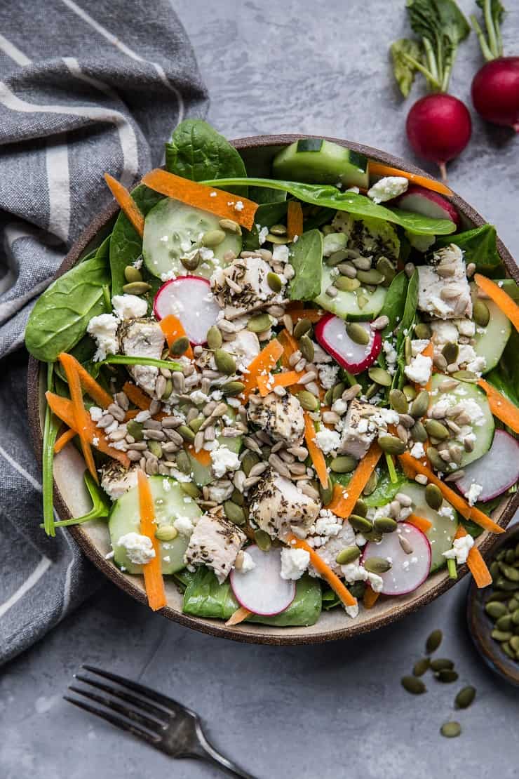 Lemon Herb Baked Chicken Spinach Salad with pumpkin seeds, radishes, cucumbers, feta, and carrots - an easy healthy Low-FODMAP salad recipe | TheRoastedRoot.net