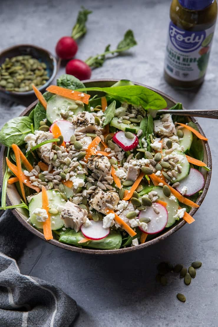 Lemon Herb Baked Chicken Spinach Salad with pumpkin seeds, radishes, cucumbers, feta, and carrots - an easy healthy Low-FODMAP salad recipe | TheRoastedRoot.net