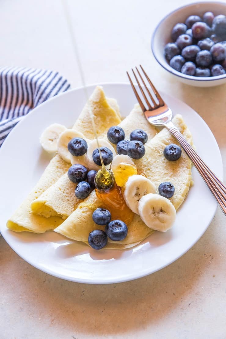 Grain-Free Paleo Crepes made with almond flour and tapioca flour - easy to prepare in your blender! | TheRoastedRoot.net #glutenfree