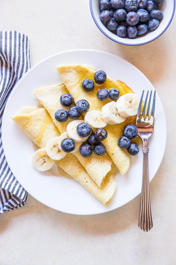 Grain-Free Paleo Crepes made with almond flour and tapioca flour - easy to prepare in your blender! | TheRoastedRoot.net #glutenfree