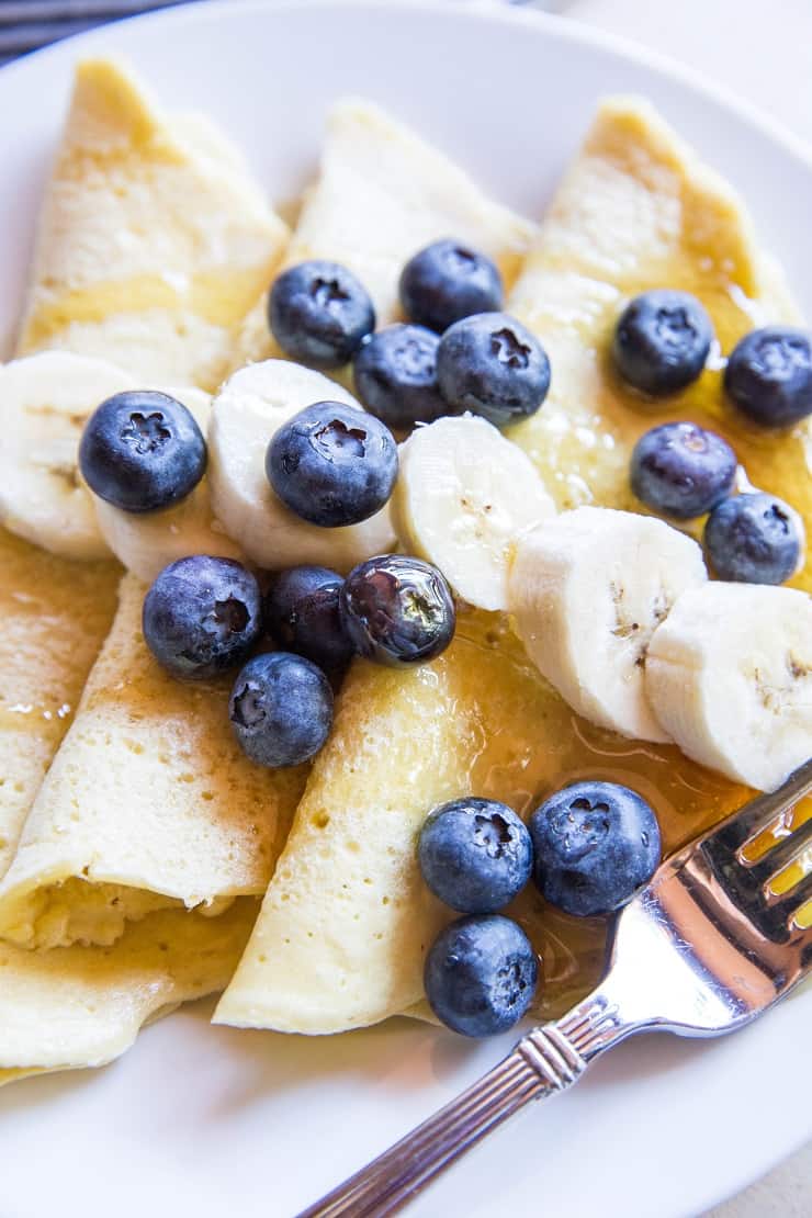 Grain-Free Paleo Crepes made with almond flour and tapioca flour - easy to prepare in your blender! | TheRoastedRoot.net #glutenfree