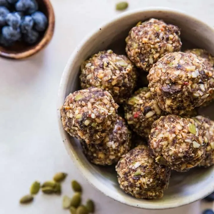 Superfood Blueberry Dark Chocolate Energy Balls made with walnuts, almonds, dates, flax seed oil, and more! A healthy snack recipe | TheRoastedRoot.net #paleo #vegan #healthy