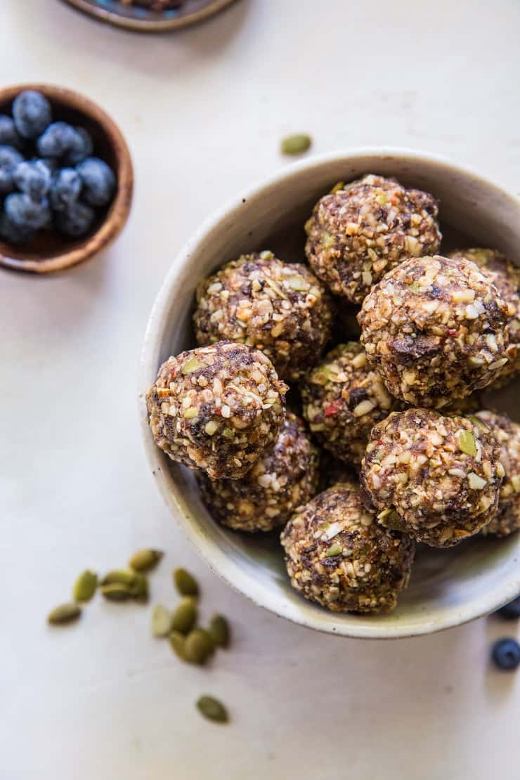 Superfood Blueberry Dark Chocolate Energy Balls made with walnuts, almonds, dates, flax seed oil, and more! A healthy snack recipe | TheRoastedRoot.net #paleo #vegan #healthy