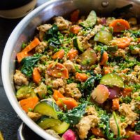 Stainless steel skillet at an angle, filled with ground turkey and vegetables.