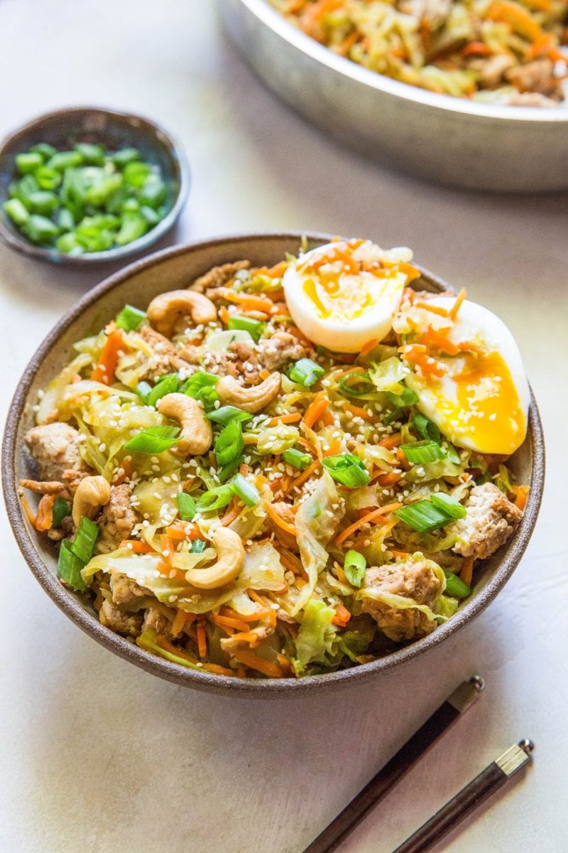 Ground Turkey Egg Roll in a Bowl with chopsticks to the side and a small bowl of green onions chopped.