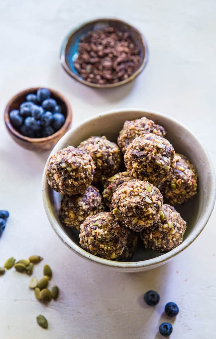 Superfood Blueberry Dark Chocolate Energy Balls made with walnuts, almonds, dates, flax seed oil, and more! A healthy snack recipe | TheRoastedRoot.net #paleo #vegan #healthy