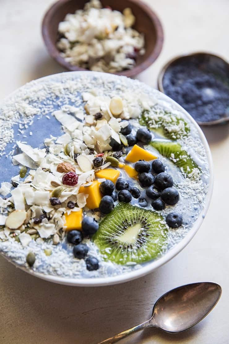 Tropical Blue Smoothie Bowl with mango, coconut, kiwi, and blueberries. Make a blue smoothie bowl with blue spirulina or blue pea powder for a healthy antioxidant packed breakfast | TheRoastedRoot.net