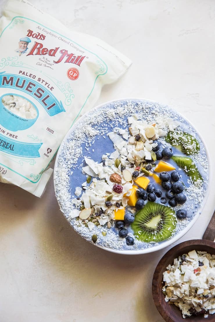 Tropical Blue Smoothie Bowl with mango, coconut, kiwi, and blueberries. Make a blue smoothie bowl with blue spirulina or blue pea powder for a healthy antioxidant packed breakfast | TheRoastedRoot.net