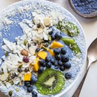 Tropical Blue Smoothie Bowl with mango, coconut, kiwi, and blueberries. Make a blue smoothie bowl with blue spirulina or blue pea powder for a healthy antioxidant packed breakfast | TheRoastedRoot.net