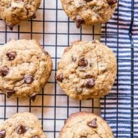 Chocolate chip cookies sitting on a wire rack to cool.