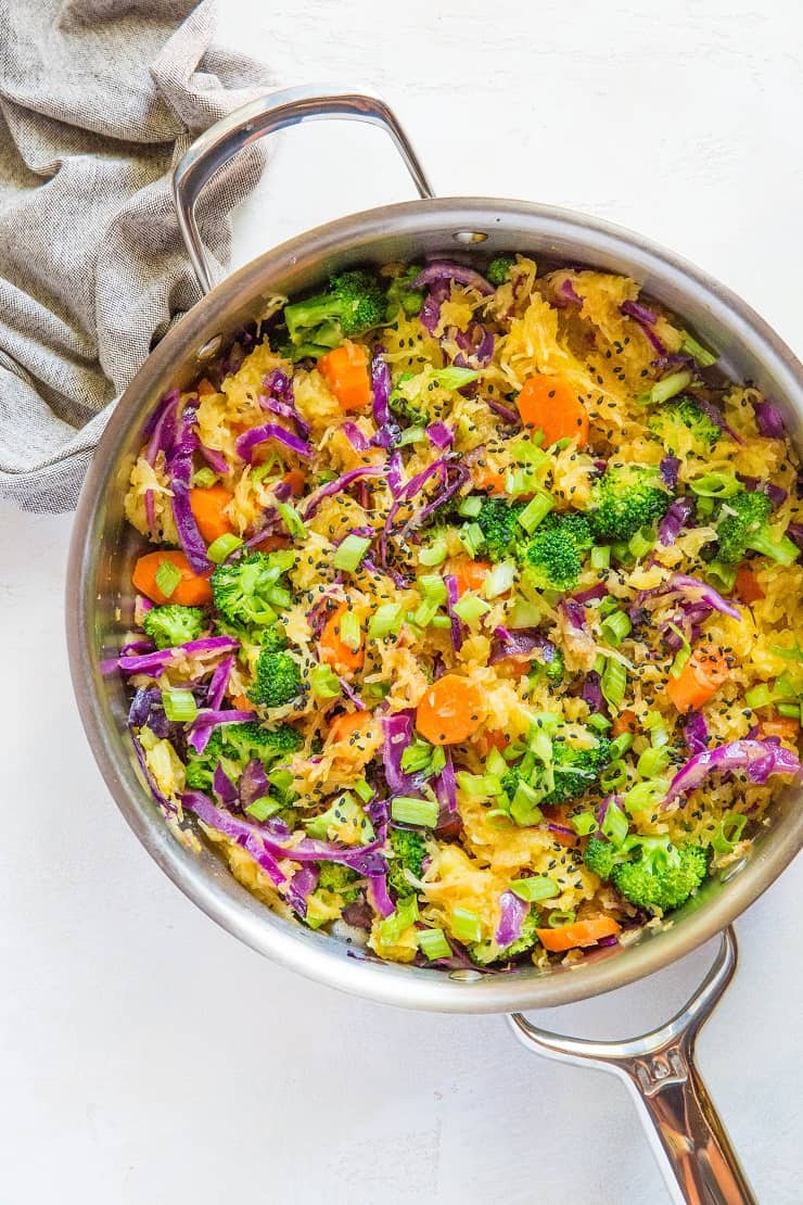 Spaghetti Squash Stir Fry with carrots, broccoli, cabbage, green onion, ginger, and coconut aminos - an easy paleo side dish | TheRoastedRoot.net #glutenfree