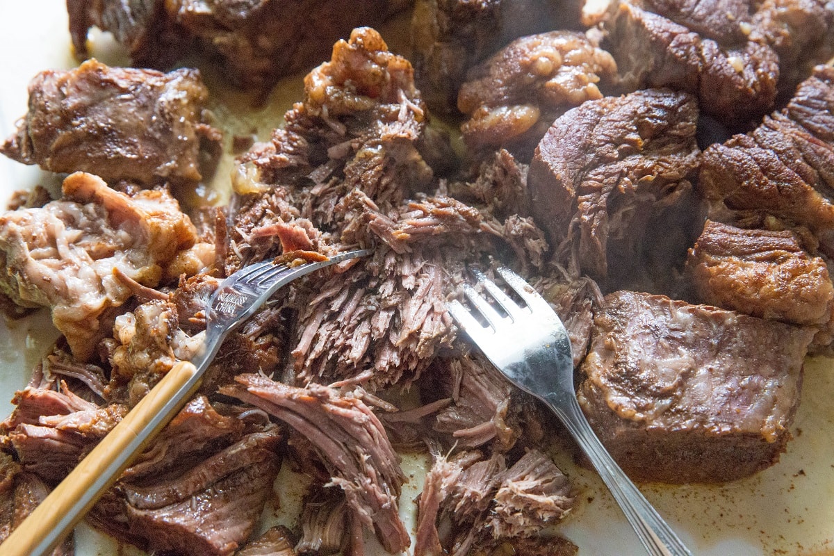 Shredded beef on a cutting board