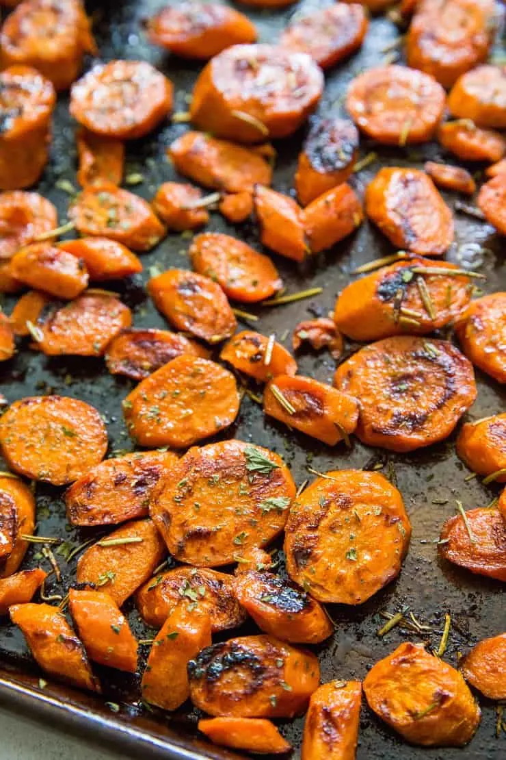Apple Cider Glazed Roasted Carrots with pumpkin seeds and rosemary is a healthy holiday side dish | TheRoastedRoot.net