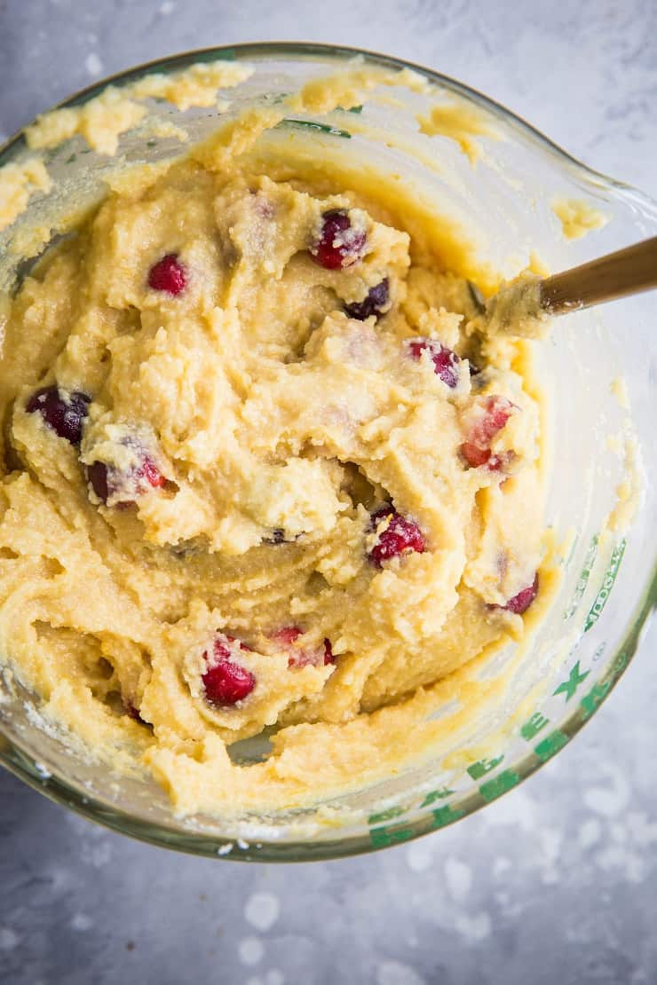 large measuring cup with cranberry orange cake batter all stirred up