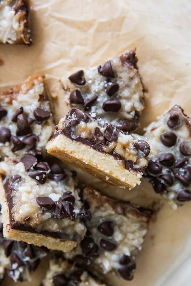 7-Layer Paleo Magic Bars on parchment paper