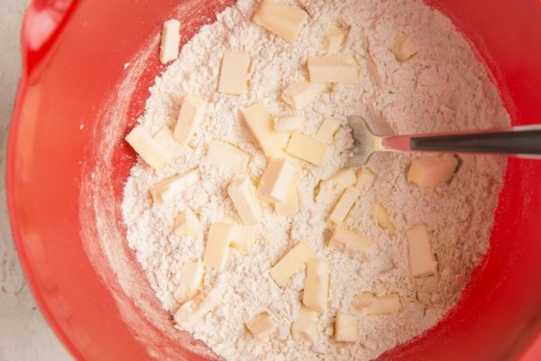 Chopped chilled butter in the mixing bowl with the flour
