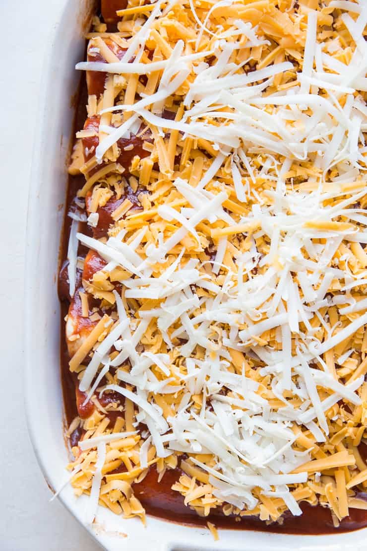 process of enchiladas with shredded cheese on top