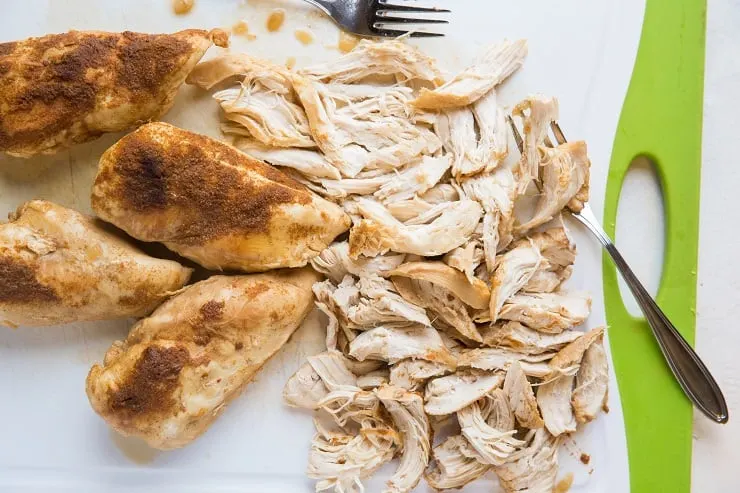 Pressure cooker shredded chicken on a cutting board