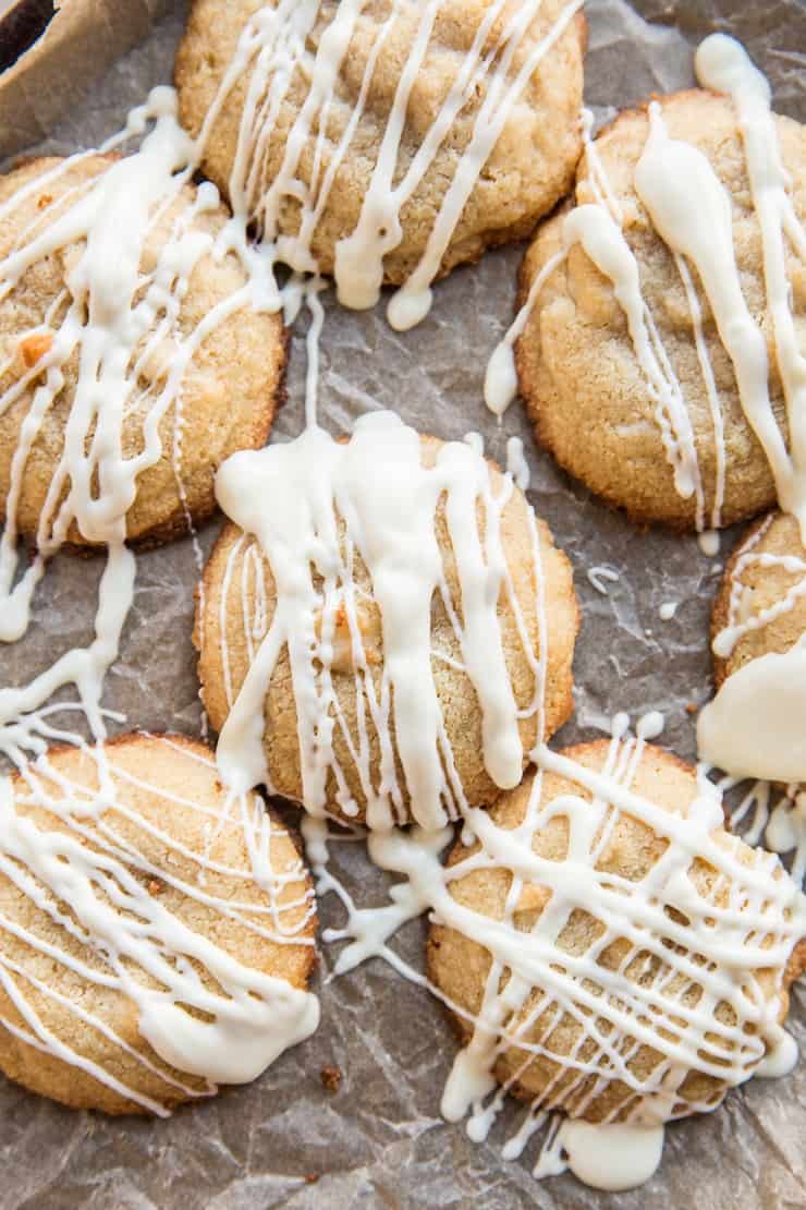Tray of white chocolate macadamia nut cookies with white chocolate drizzle