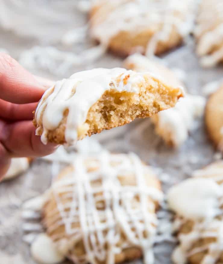 Hand holding paleo white chocolate cookie with bite taken out