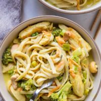 Close up top down shot of bowl of curry noodles with napkin