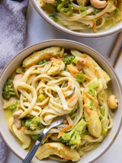 Close up top down shot of bowl of curry noodles with napkin