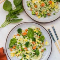 Basil fried rice on two plates with a red napkin and chopsticks