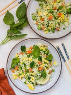 Basil fried rice on two plates with a red napkin and chopsticks