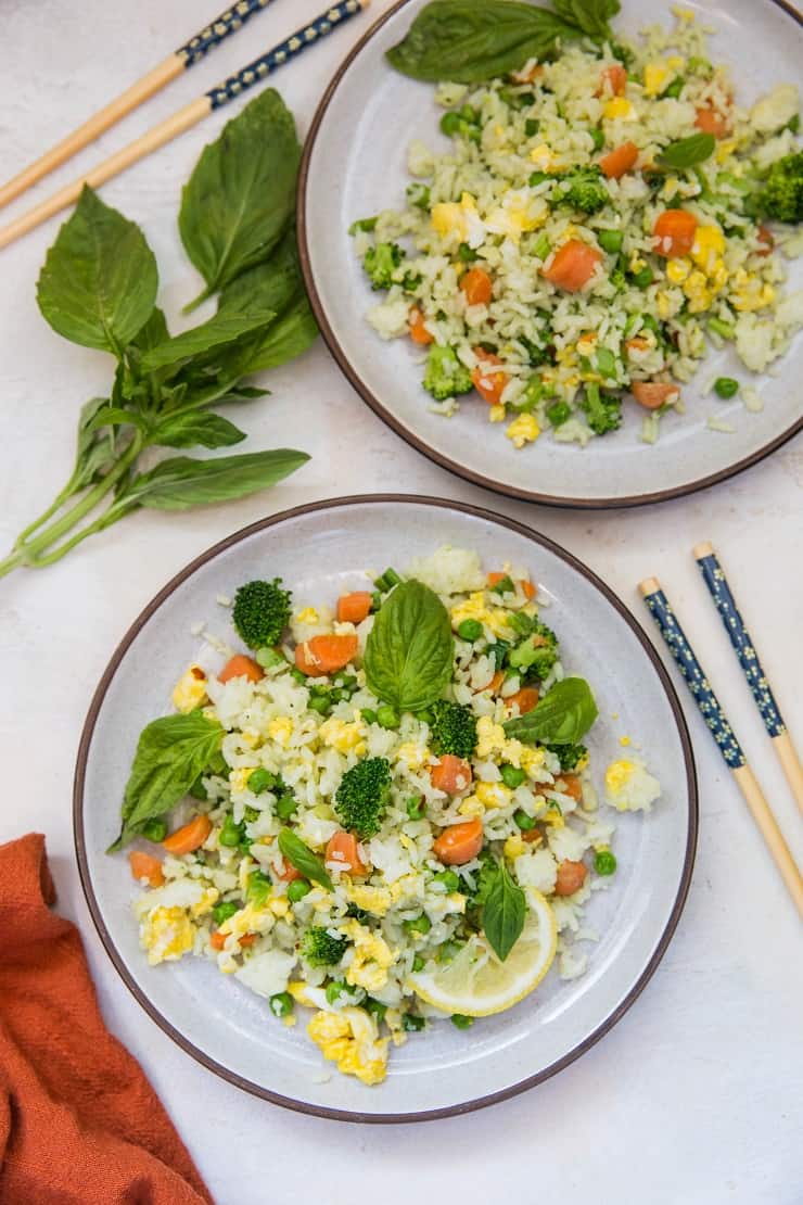 Basil fried rice on two plates with a red napkin and chopsticks