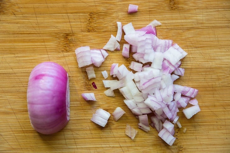 red onion chopped on a wooden cutting board