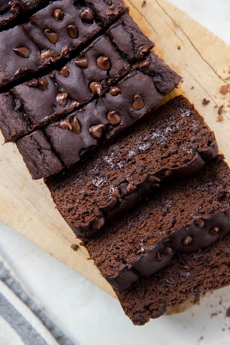 close up black bean banana bread with slices and chocolate chips visible